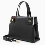 A black leather tote bag with gold-tone metal accents and a brand emblem on the front, accompanied by a detachable strap.