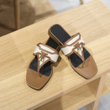 Pair of black and white shoes with brown accents on a wooden surface